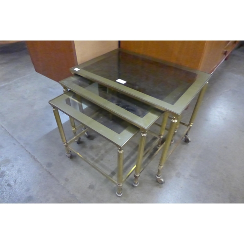 105 - An Italian brass and glass topped nest of tables