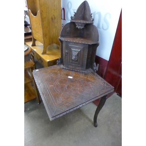 107 - A Victorian Jacobean Revival carved oak corner stand