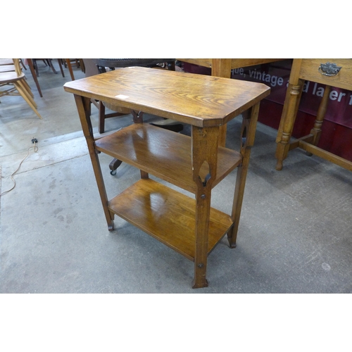 108 - An Arts and Crafts oak three tier occasional table