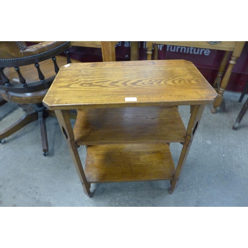 108 - An Arts and Crafts oak three tier occasional table