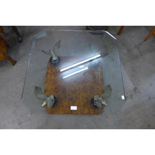 114 - A Maison Charles style walnut effect, brass eagle and glass topped coffee table