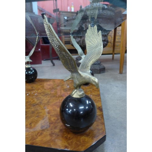 114 - A Maison Charles style walnut effect, brass eagle and glass topped coffee table