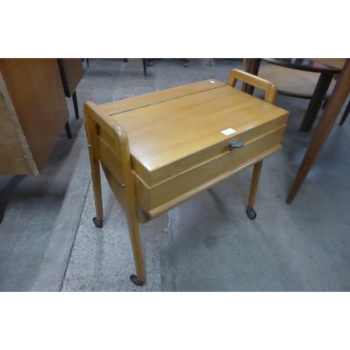 79 - A teak sewing box and a beech wall hanging coat rack