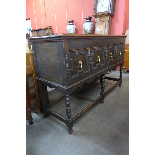 24 - An early 20th Century Jacobean Revival oak geometric moulded dresser