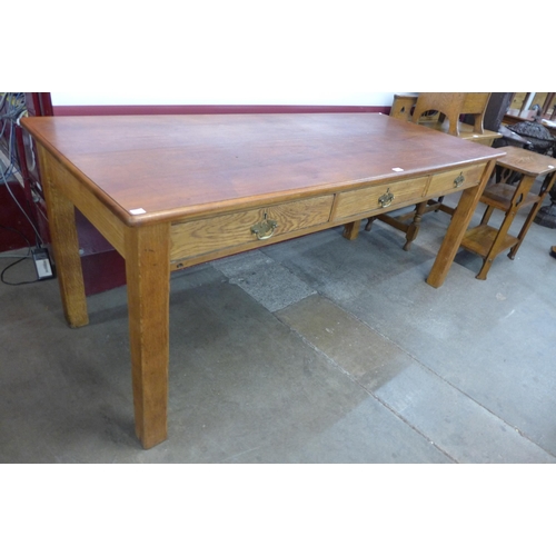 175 - A large early 20th Century oak and beech three drawer library table