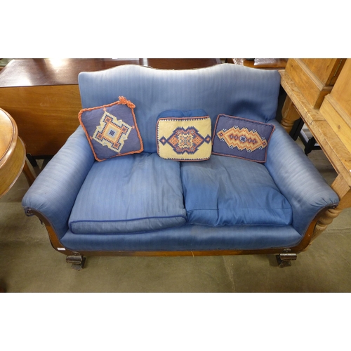 248 - A Victorian mahogany and blue fabric upholstered scroll arm settee