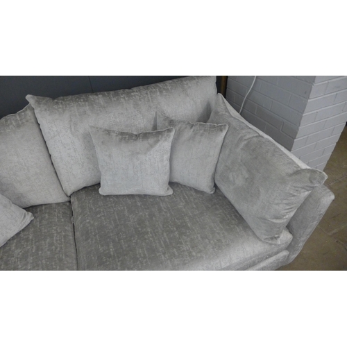 1314 - A grey crushed velvet upholstered three seater sofa