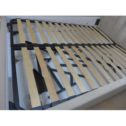 1515 - A champagne upholstered kingsize storage bed frame