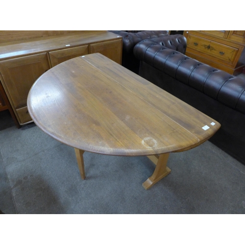 105 - An Ercol Blonde elm and beech drop leaf table