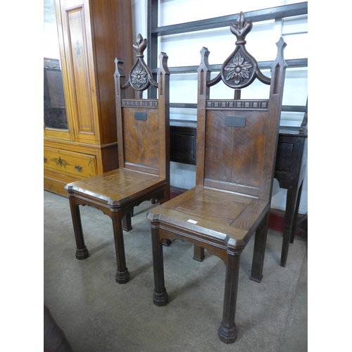 14 - A pair of Victorian Gothic Revival oak hall chairs, manner of A.W.N. Pugin