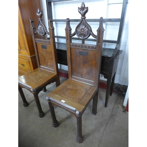 14 - A pair of Victorian Gothic Revival oak hall chairs, manner of A.W.N. Pugin