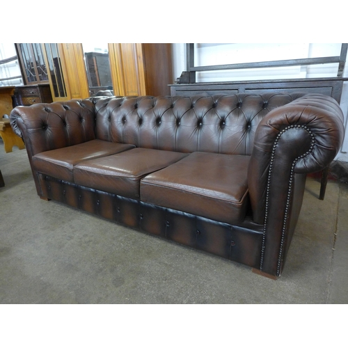 16 - A brown leather Chesterfield  settee