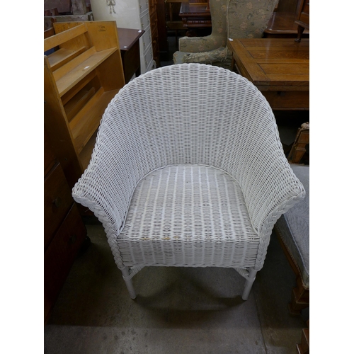 162 - An elm rush seated ladderback rocking chair and a Lloyd Loom chair