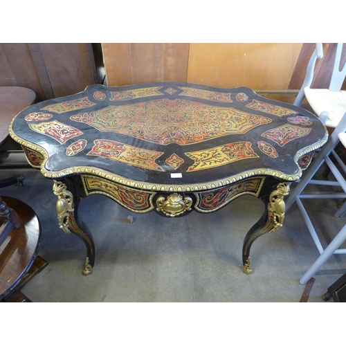 192 - A French style ebonised, brass and faux tortoiseshell bureau plat