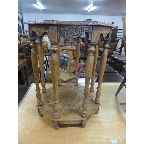 214 - A carved oak two tier octagonal occasional table