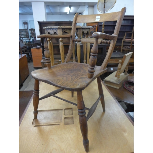 215 - A Victorian elm and beech kitchen elbow chair