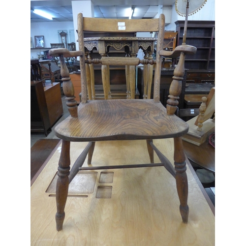 215 - A Victorian elm and beech kitchen elbow chair