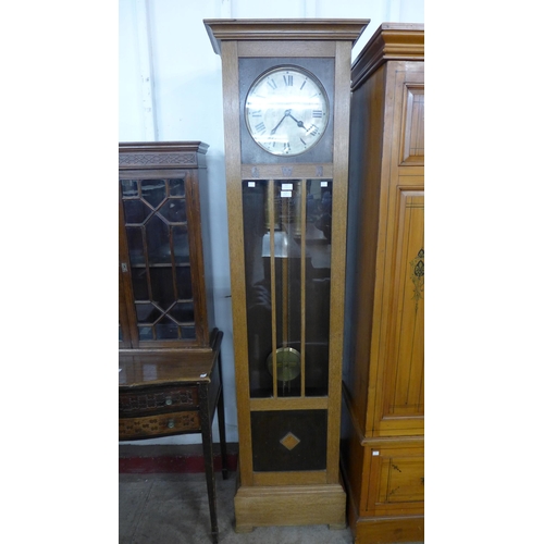 227 - An early 20th Century oak triple weight longcase clock, bearing inlaid G.W.R. letteringn to case