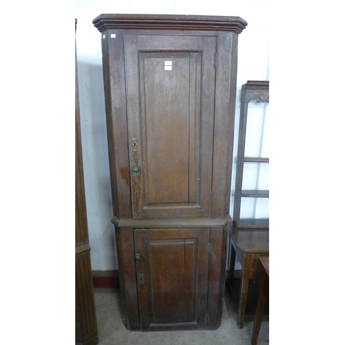 230 - A George III oak freestanding corner cupboard