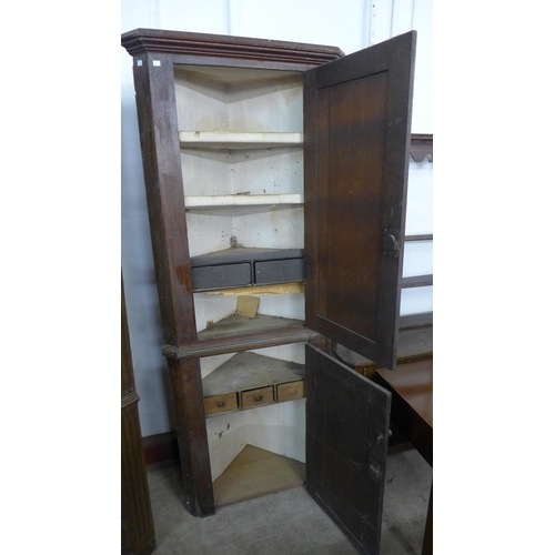 230 - A George III oak freestanding corner cupboard