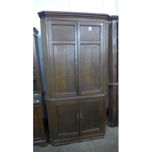 231 - A George III oak freestanding corner cupboard