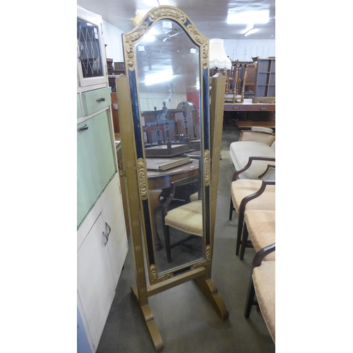 246 - An ebonised and gilt cheval mirror