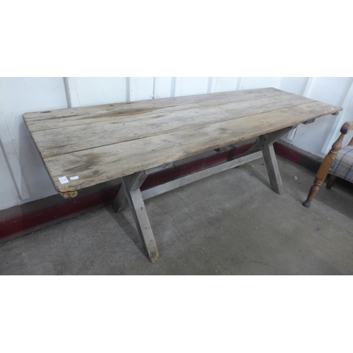 256 - A Gothic pine x-frame farmhouse refectory table