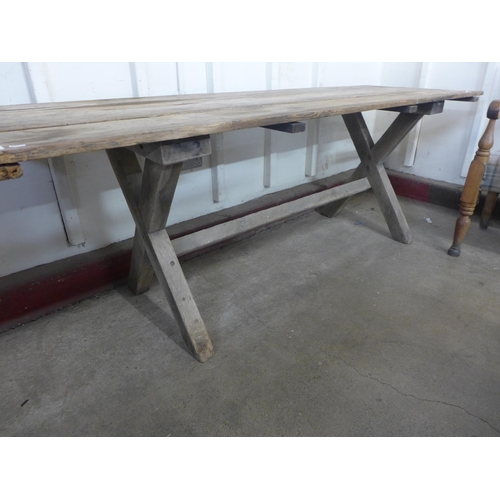 256 - A Gothic pine x-frame farmhouse refectory table