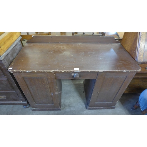 260 - A Victorian stained pine kneehole desk