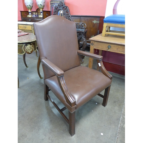 27 - A mahogany and brown leather library armchair