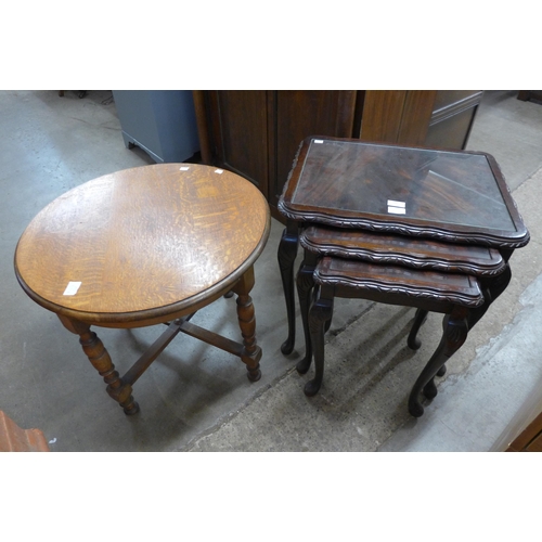 300 - An oak circular occasional table and a mahogany nest of tables