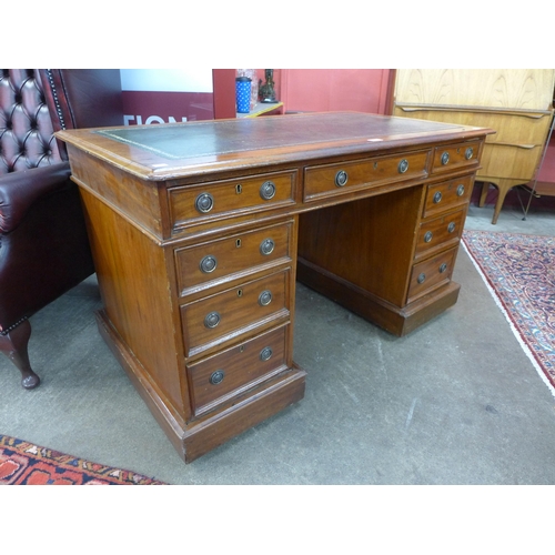 34 - A Victorian mahogany and green leather topped pedestal desk