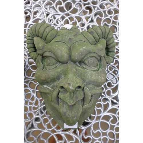 341 - A grotesque concrete wall hanging mask