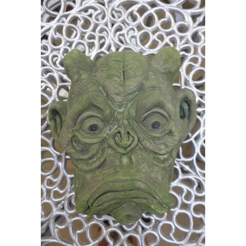 342 - A grotesque concrete wall hanging mask