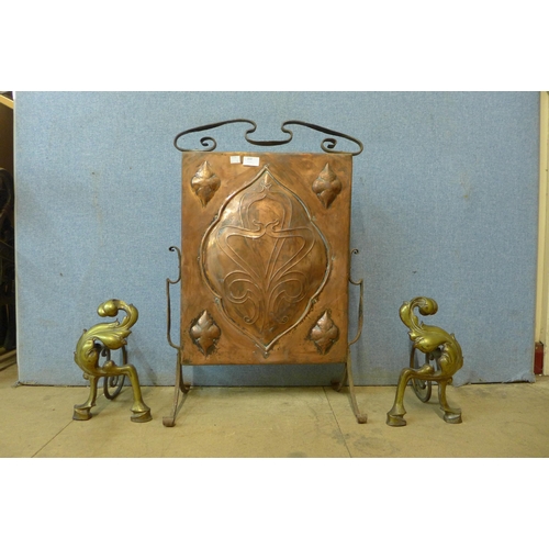 350 - An Art Nouveau wrought iron and copper fire screen and a pair of French brass andirons