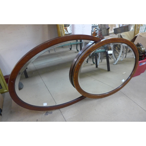 387 - Two oval mahogany framed mirrors