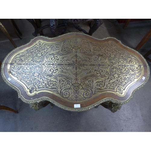 6 - A French Boulle style mahogany and brass inlaid serpentine single drawer centre table