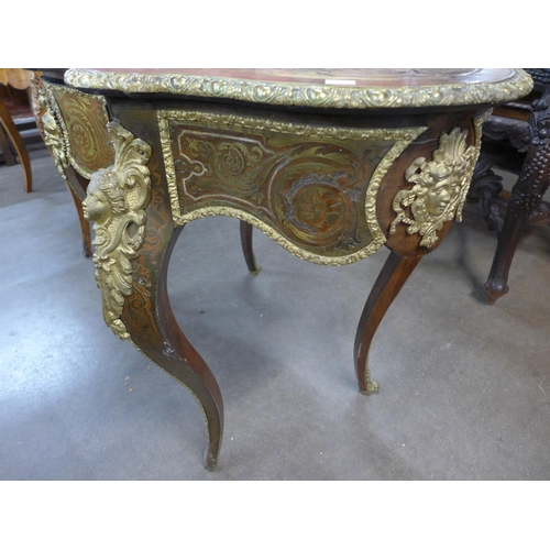 6 - A French Boulle style mahogany and brass inlaid serpentine single drawer centre table