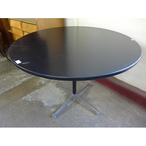 69 - An Eames style circular black and steel based kitchen table