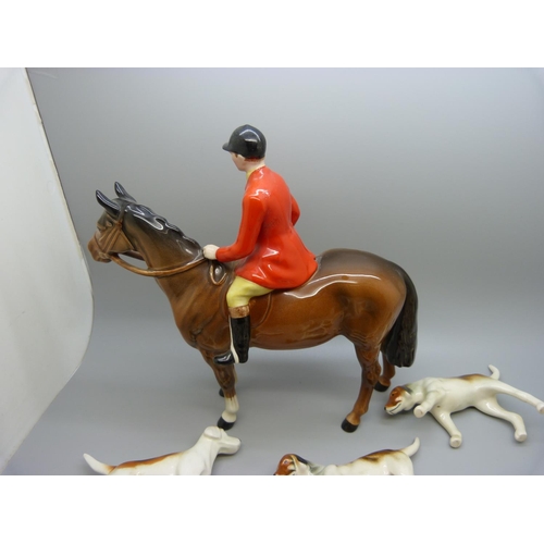 633 - A Beswick Huntsman, no. 1501, four Beswick hounds and five other hounds