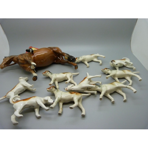 633 - A Beswick Huntsman, no. 1501, four Beswick hounds and five other hounds