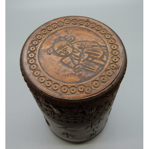 634 - A carved bamboo cannister with translation, 12.5cm