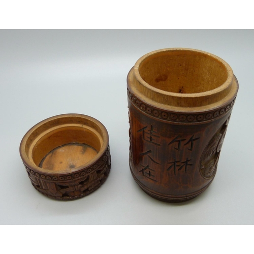 634 - A carved bamboo cannister with translation, 12.5cm