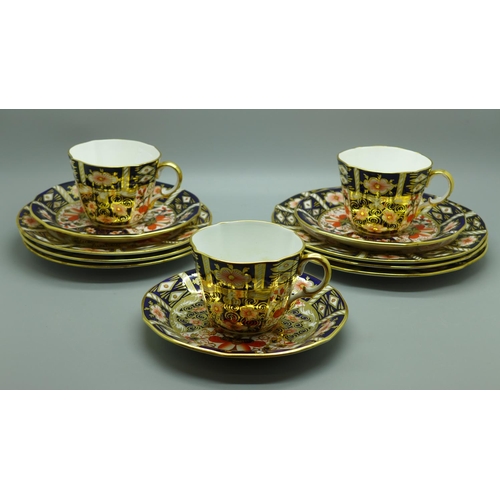 674 - Three Royal Crown Derby 2451 pattern tea cups, saucers, tea plates and side plates