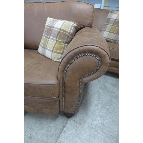 1549 - A County brown faux leather button back and studded three seater sofa and loveseat