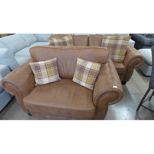 1549 - A County brown faux leather button back and studded three seater sofa and loveseat