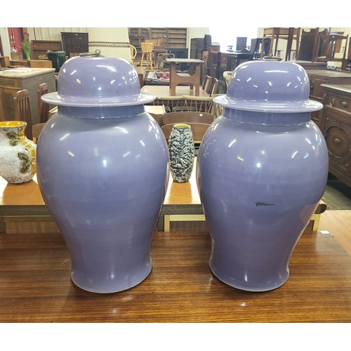 128 - A pair of oriental purple porcelain ginger jars and covers