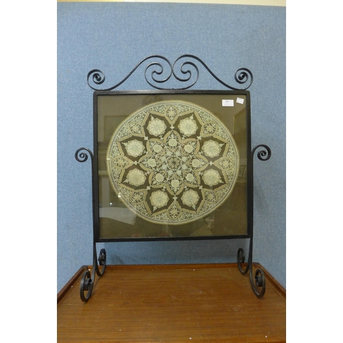 266 - A wrought iron fire screen