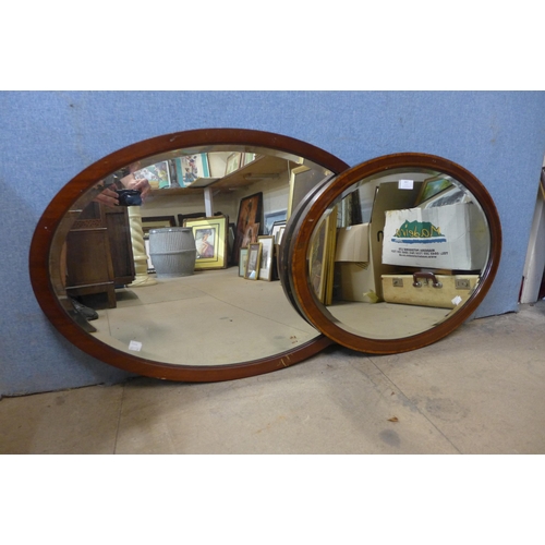 276 - Two oval mahogany framed mirrors