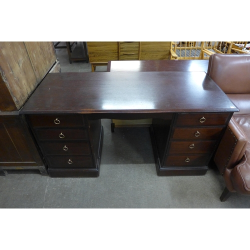 102 - A Stag Minstrel mahogany desk and chair